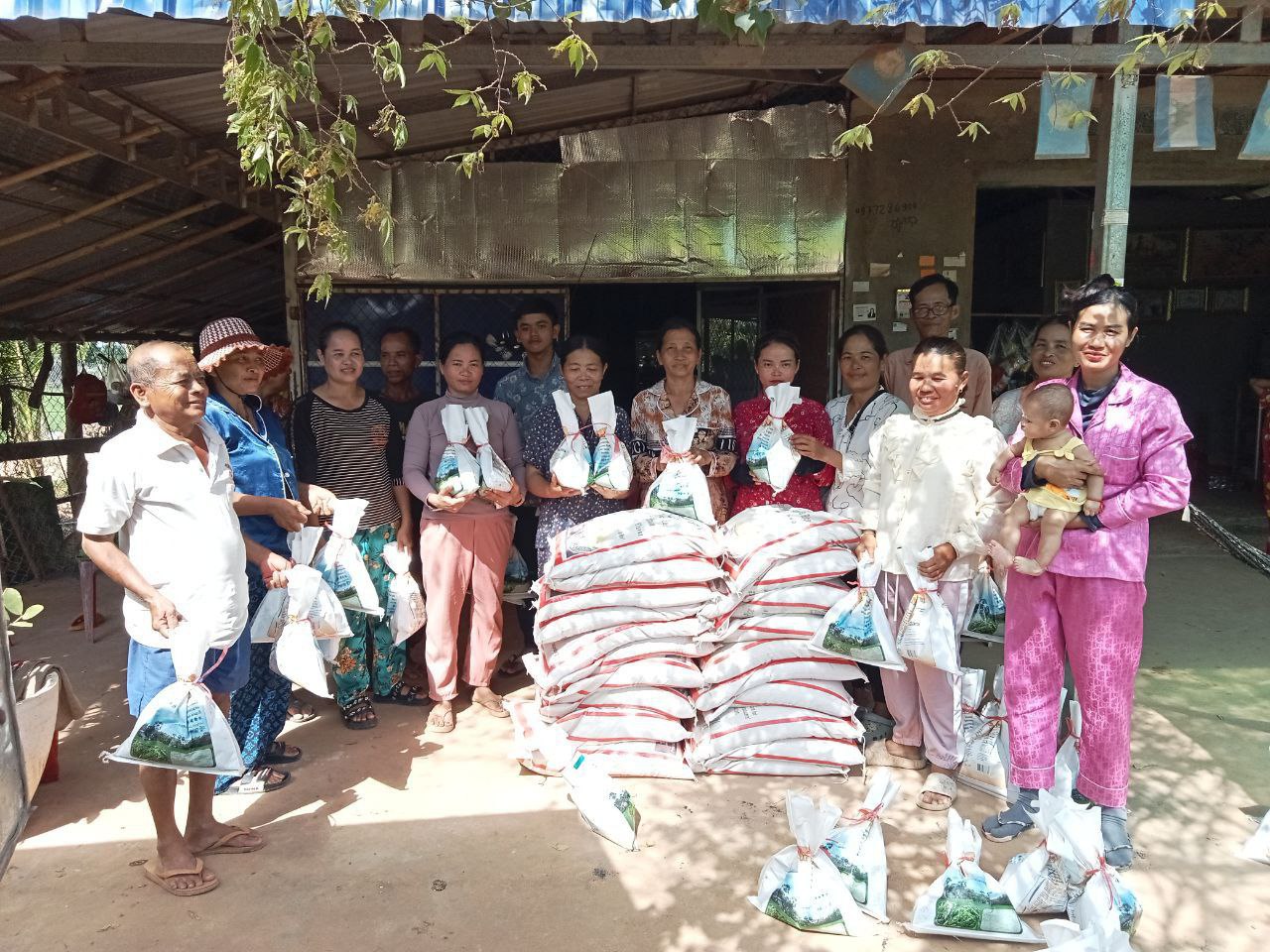 A group of Cambodians receive cricket eggs and feed.