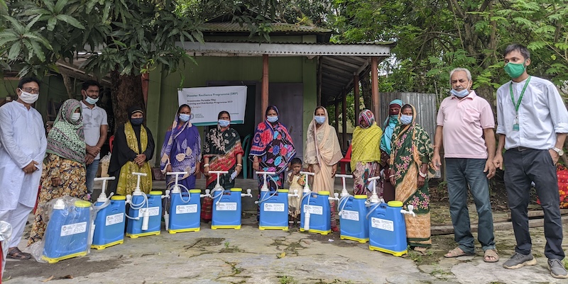 A group of women stand behind the Dreamwater filters next to Footsteps members