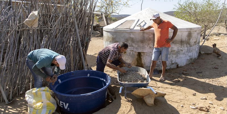 Three men install the RAC-SAF greywater reuse system in Pernambuco, Brazil.