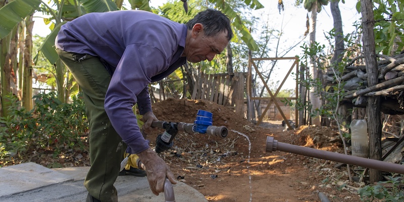 A man sets up the greywater reuse system in his land in Pernambuco, Brazil.