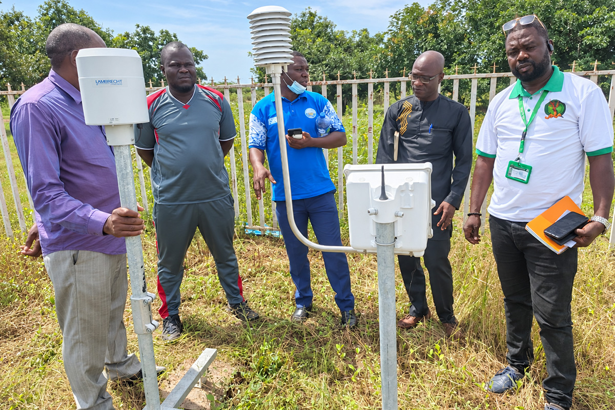 A group of men work around a meteorological weather station in Burkina Faso
