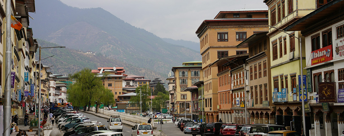 Street scene, Norzin Lam 1, Thimphu, Bhutan, with mountains in the background.