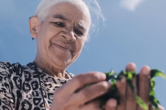 Fisher Hilda April Adams holds algae from the ocean